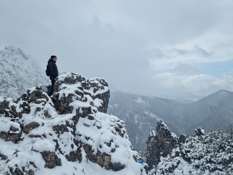 author on top of a mountain durning winter